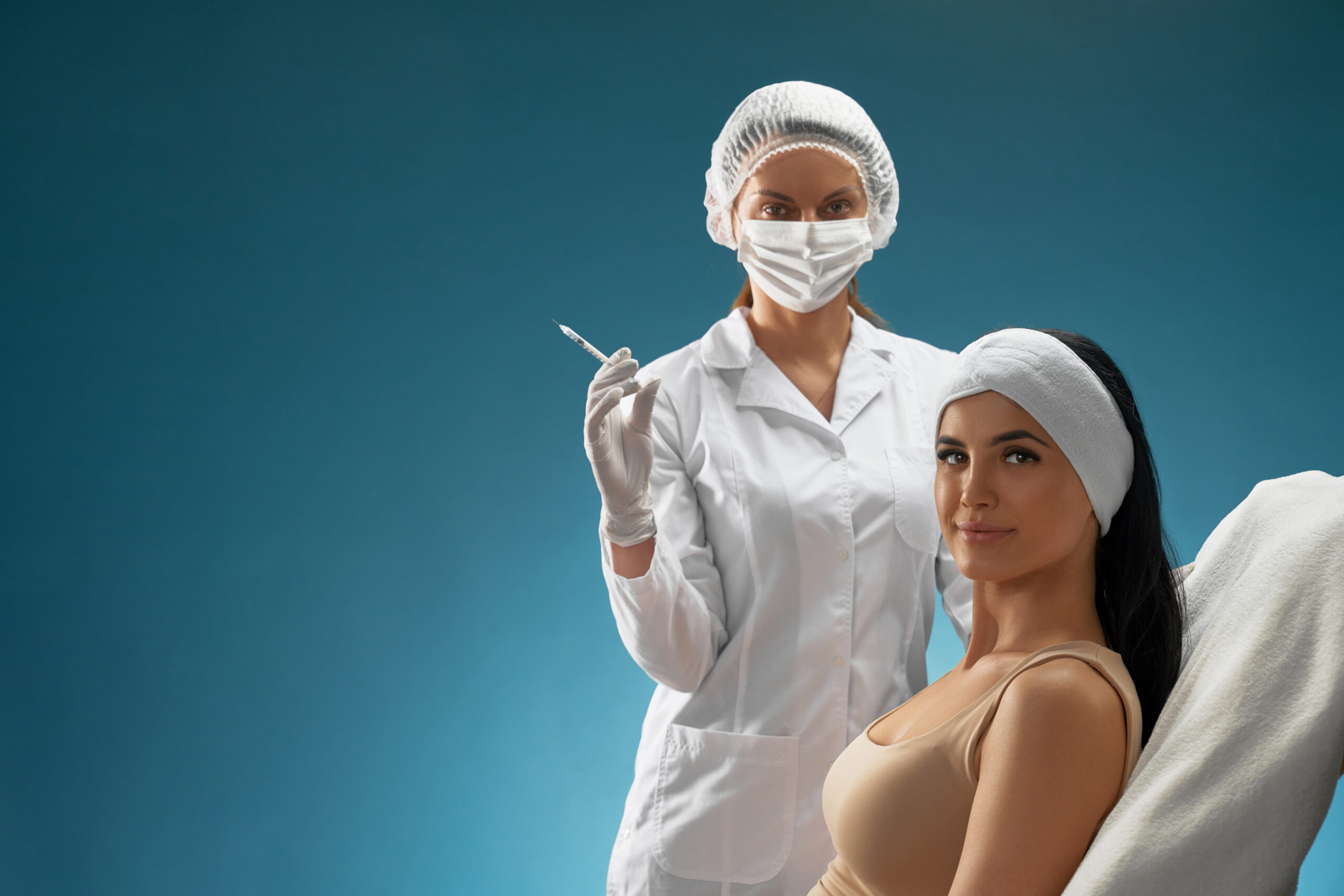cosmetologist with syringe and patient on chair.