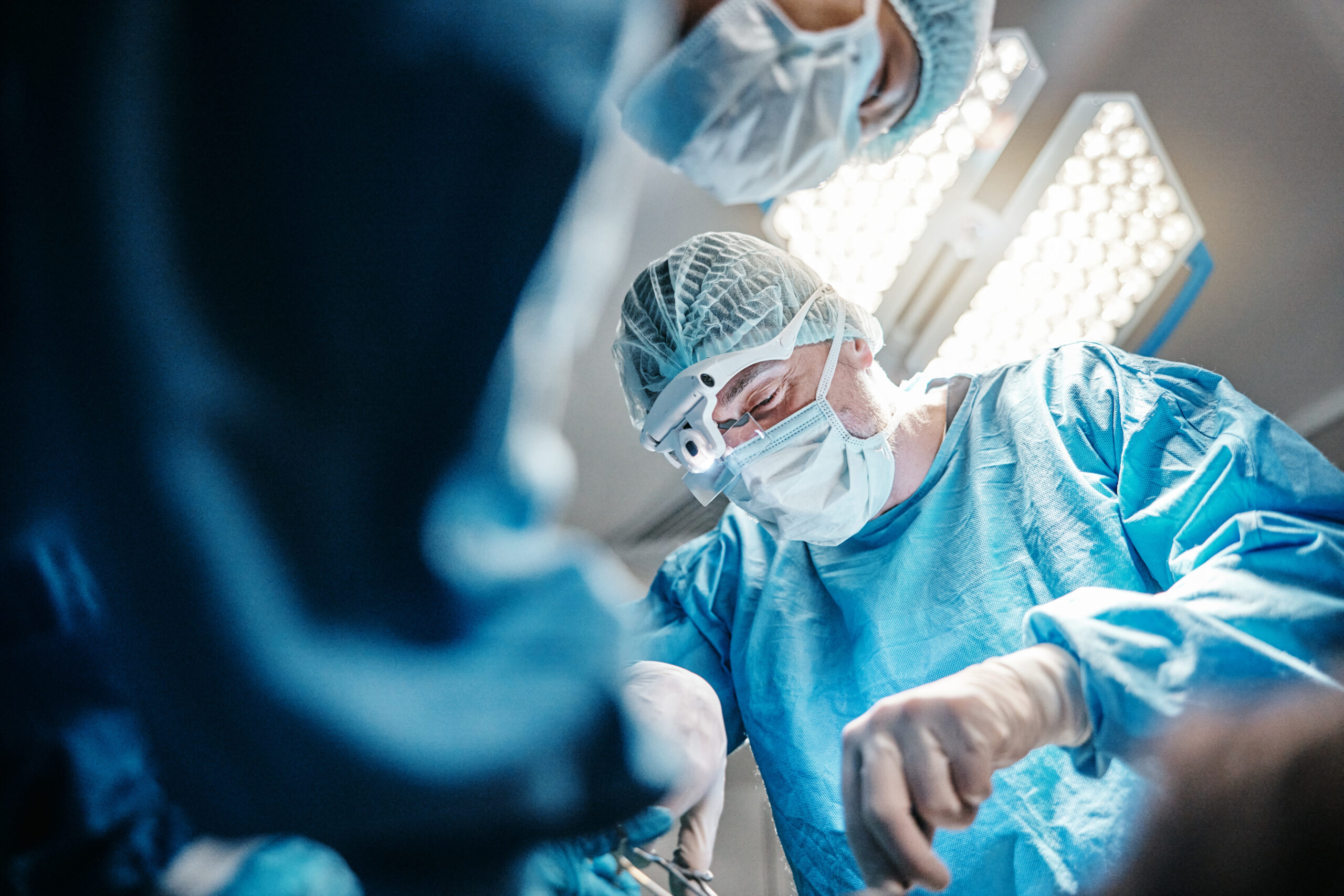 hospital theatre surgeon with teamwork surgery working together healthcare with mask medical man group people as doctors clinic service collaboration with tools